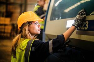 Factory engineer woman standing confidence to control panel switch. smart industry worker operating. photo