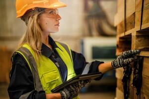A female carpenter focuses on quality control while working in a wood product manufacturing site. photo
