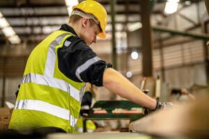 In a manufacturing setting, workers in hard hats ensure the quality of wooden products. photo
