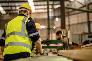 A group of carpenters assesses the finish of wooden products during a workshop session. photo