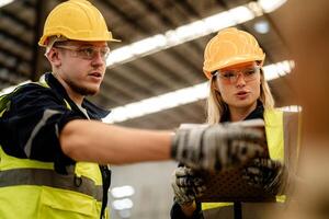 Workers assess the quality of timbers in a warehouse as part of smart industry operations. photo