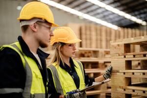 Workers focus on ensuring the quality of timber materials in a smart industry warehouse. photo