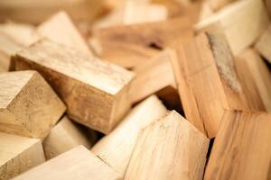 A team of workers reviews wooden timbers in a warehouse setting for quality checks. photo