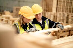Workers ensure timber quality in the warehouse, aligning with production goals. photo