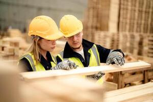 Engineers check timber quality in a warehouse to support efficient wood production. photo