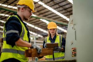 Workers review timbers in a warehouse to ensure their condition meets quality standards. photo