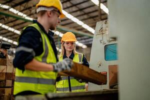 Workers inspect timbers during a routine operation in the warehouse. photo