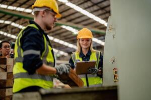 Engineers check timber materials in the warehouse for use in manufacturing. photo
