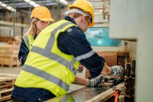 Engineers check wooden timbers during a walkthrough of the warehouse facility. photo
