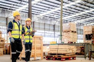 Workers evaluate timber materials during a routine inspection of the factory warehouse. photo