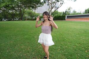 A joyful young woman dances in harmony indoo rs, with large windows and lush plants enhancing the pure joy. photo