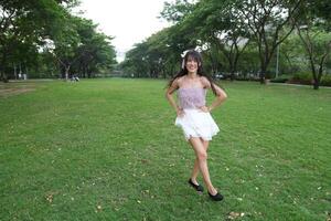 A joyful young woman danc es in harmony indoors, with beautiful greenery and a scenic view enhancing the harmony and peace. photo
