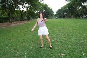 A joyful young woman d ances in harmony indoors, with beautiful greenery and a scenic view enhancing the harmony and peace. photo