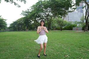 A serene indoor sp ace with large windows and a scenic view surrounds a dancing woman, capturing harmony and peace. photo