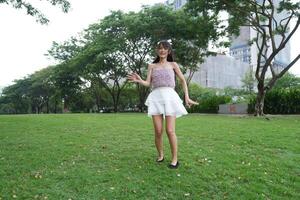 A wo man dances happily indoors, set against beautiful greenery and lush plants, symbolizing freedom and energy. photo