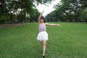 In a c alm indoor area, a woman dances freely near large windows and a scenic view, radiating freedom and energy. photo