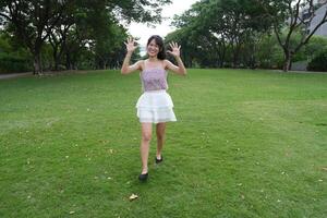 A woman dance s happily indoors, set against large windows and a scenic view, symbolizing harmony and peace. photo