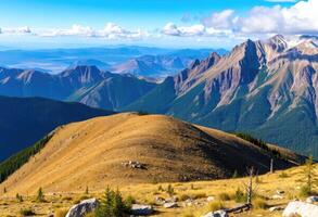 a mountain range with a blue sky and clouds photo