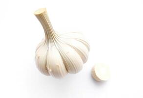 a garlic bulb and a small piece of garlic photo