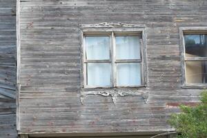 Old Weathered Building with Distressed Wooden Siding and Windows photo