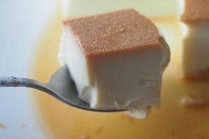 Caramel custard pudding on a plate on table photo