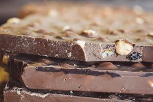 Indulgent and Delicious Chocolate Bar Generously Stacked with Nuts photo