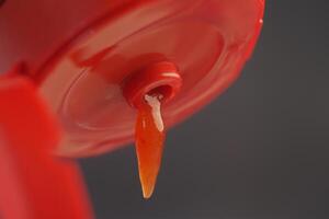 A CloseUp of a Ketchup Bottle that has an Open Lid Ready to Use for Dipping and Adding Flavor photo