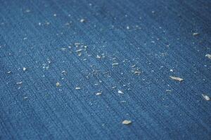 Small Dust Particles on a Blue Fabric Surface Are Visible to the Eye photo