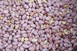 Close-Up Shot of Raw Peanuts With Textured Shells in Bulk photo