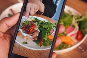 Mobile Photograph of a Delicious Meal on a Wooden Dining Table photo
