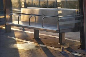 Modern Bus Stop Bench with Glass, beautifully reflecting sunlight photo