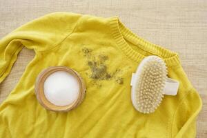 Cleaning Tools for Removing Stains on a Yellow Sweater That Needs Attention photo