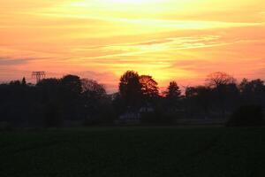 Agricultural lanscape in Mecklenburg-Vorpommern, Germany, under a burning evening sky. photo