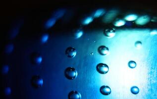 Abstract background of illuminated blue bubbles. photo