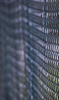 Abstract shot of a green wire mesh fence with defocusing effect. photo