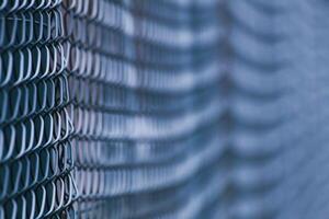 Abstract shot of green wire mesh fence with defocusing effect photo