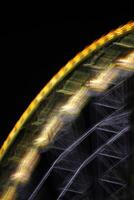 Ferris wheel in the night with motion blur. photo