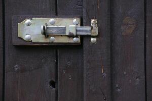 Door latch hanging at the outside of a gate. photo