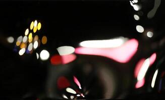 Distorted reflections of lights in the night on a fun house mirror. photo