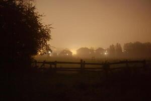 Rural suburb of Greifswald, Mecklenburg-Vorpommern, Germany, covered in fog and mist in the evening. photo