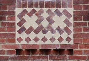 Texture of red brick wall with plastered ornaments. photo