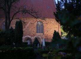 Town church in Neuenkirchen near Greifswald, Mecklenburg-Vorpommern, Germany with cemetary. photo