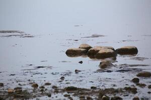 Stones lying in reflecting water photo