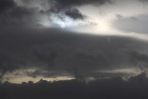 Sun shining through impressive and dense cloudscape. photo