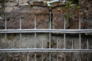 Snow of an old fashioned metal fence. photo