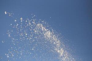 Water drops spraying from a fountain photo
