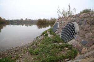 Lake in Greifswald, Mecklenburg-Vorpommern, Germany, with pipes for flood protection. photo