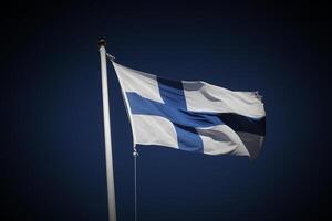 Flag of Finland on dark blue sky. Vignetting was added. photo