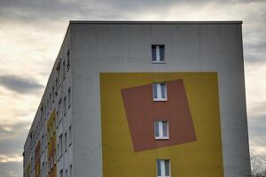 Part of a generic building reflecting the architectural style which was common in the GDR. It is decorated with squares. photo