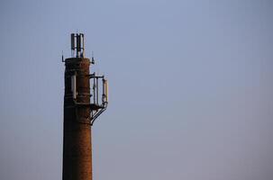 Old chimney used as a base for radio transmitters. photo